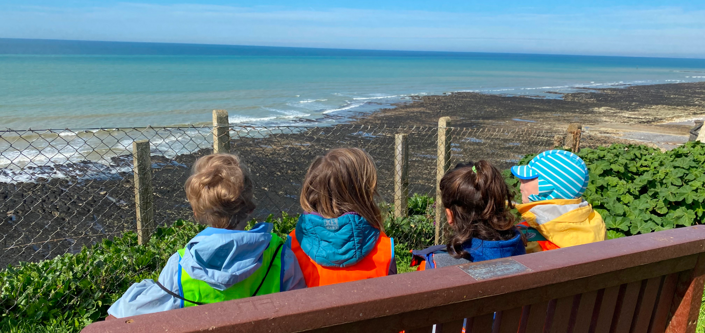 Children sat by the sea